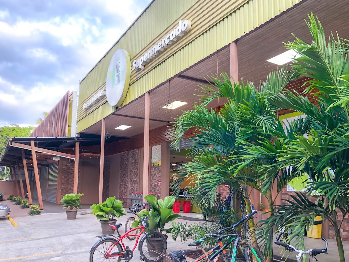 Super Negro storefront with tropical plants and bicycles